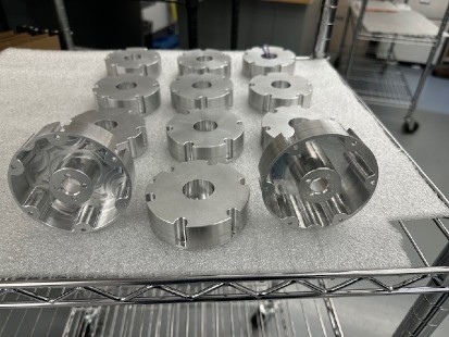 metal fabrication components on table at machine shop